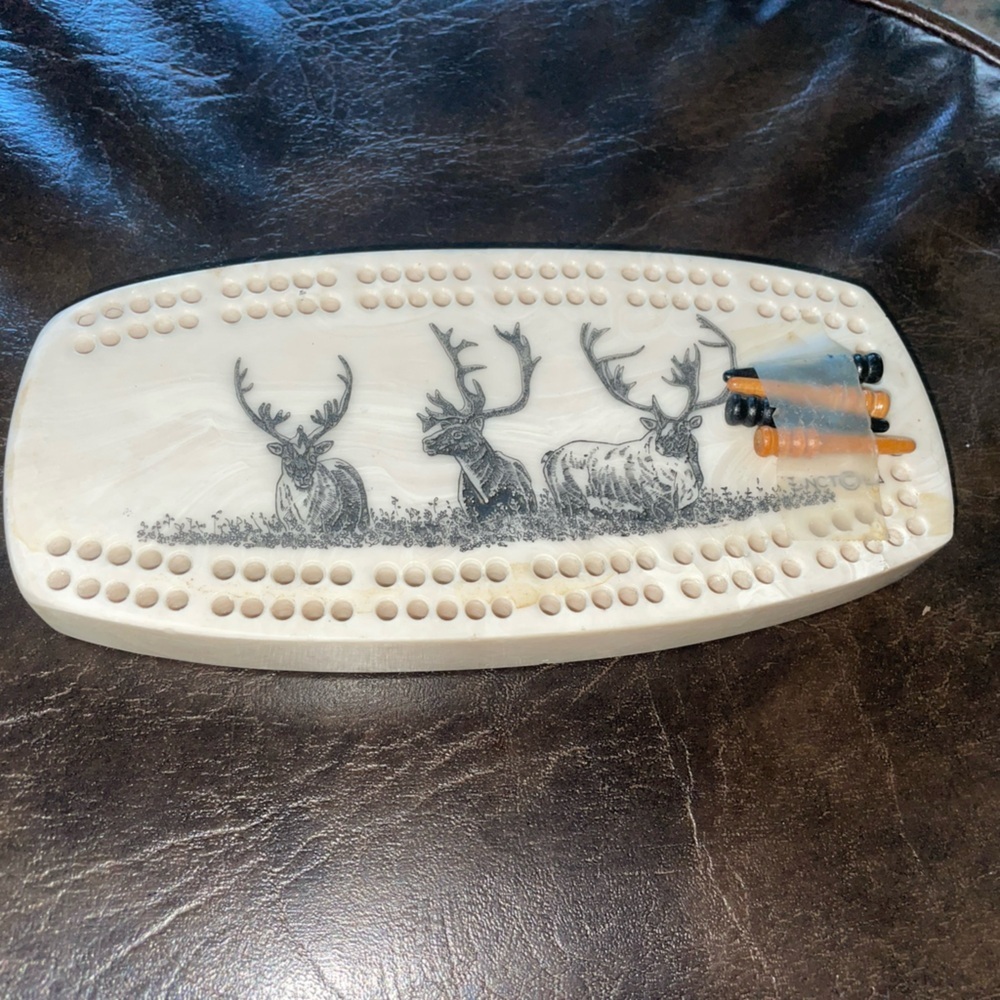 Extremely unique stone mini Cribbage board with four pegs.